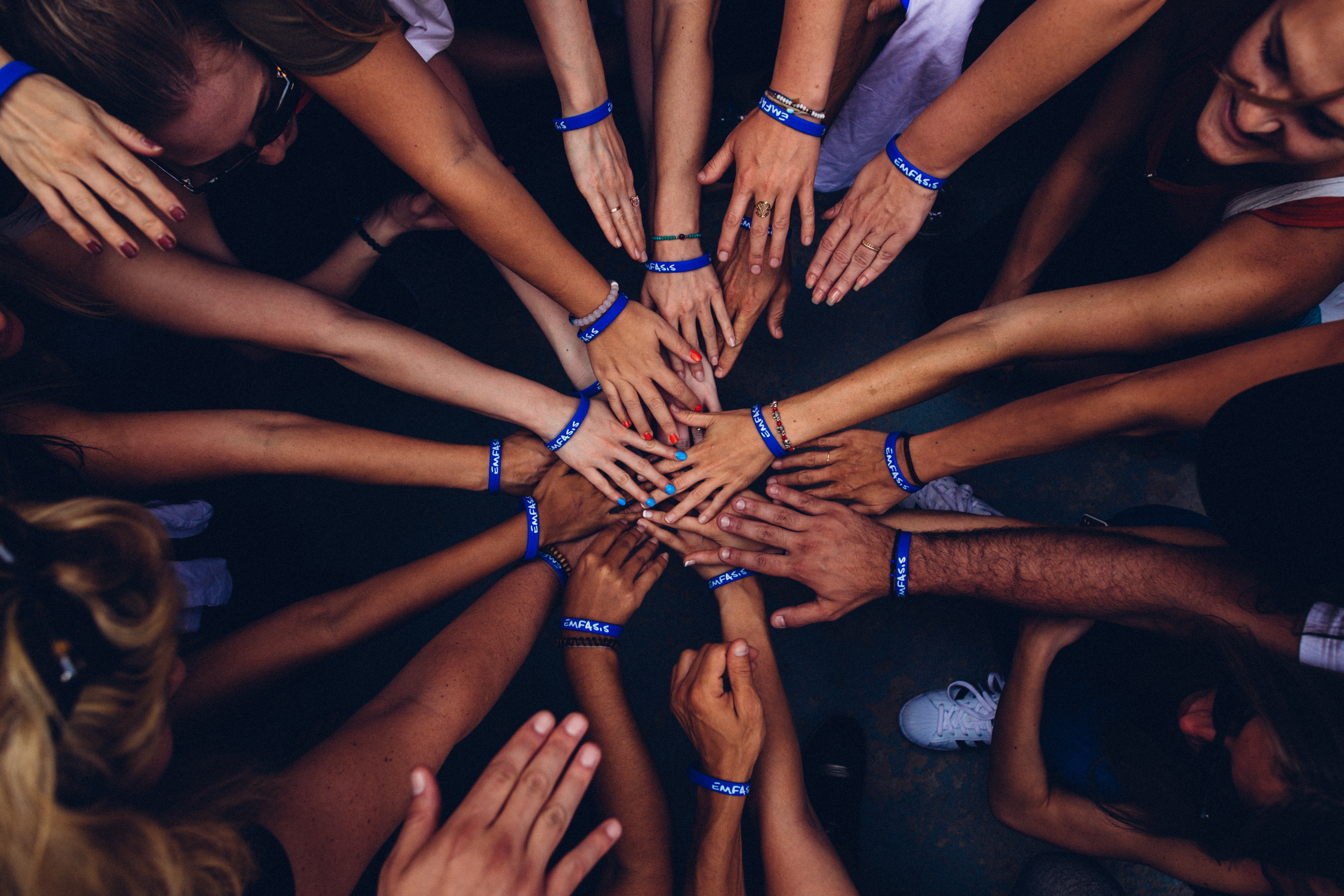 Community members joining hands in a circle